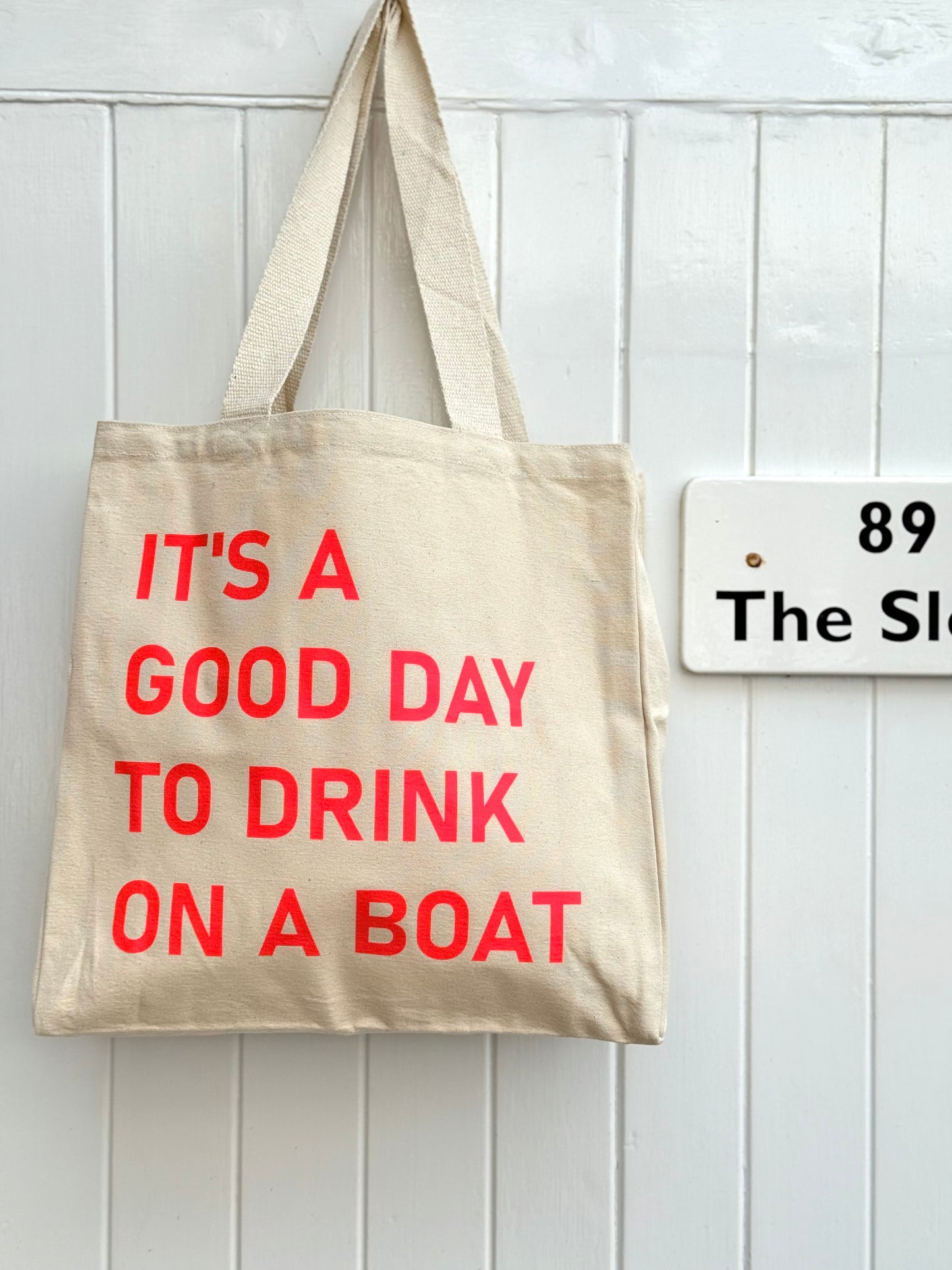 It’s a good day to drink on a boat canvas tote bag natural with neon red text